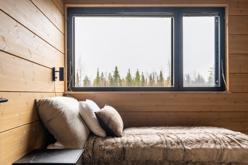The upper landing with a daybed made up under the window, cushions along the wall.
